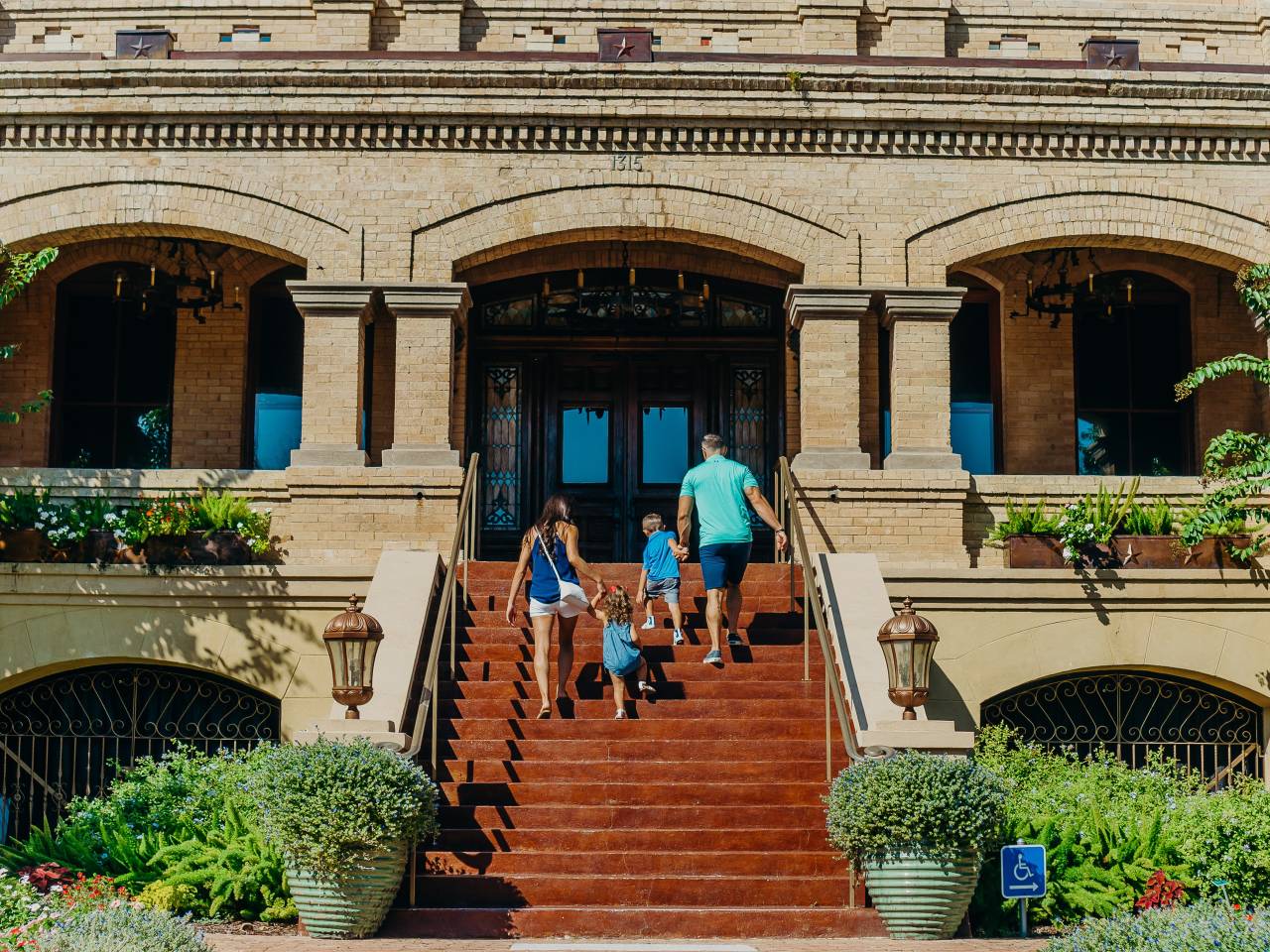 A family ascends the stairs of the Bryan Museum in Galveston, TX.