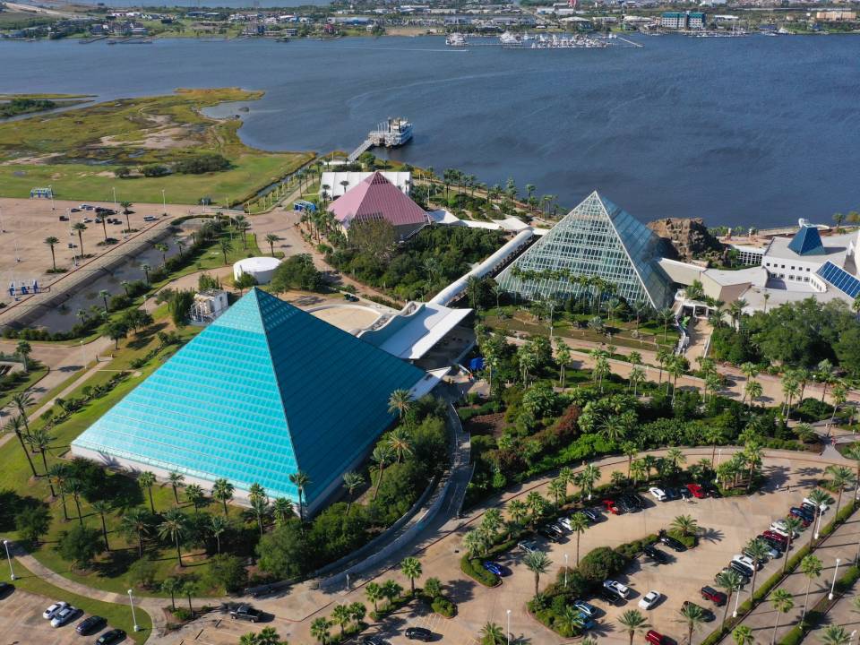 Aerial view of the 3 pyramids at Moody Gardens, one is bright blue, one is pink and one is clear