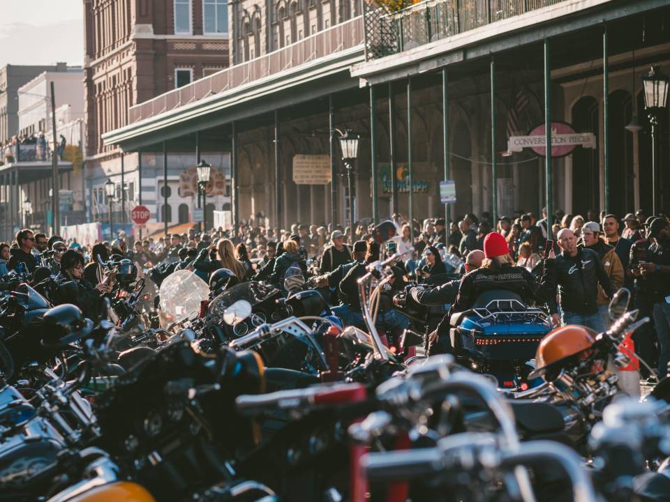 Crowds watch as motorcycles drive through the Lone Star Rally